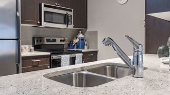 A kitchen with stainless steel appliances and granite counter tops